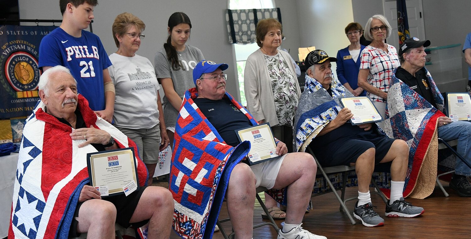 Four of the 47 veterans who received quilts from the Quilts of Valor organization Saturday at the Village of Buckingham Springs.