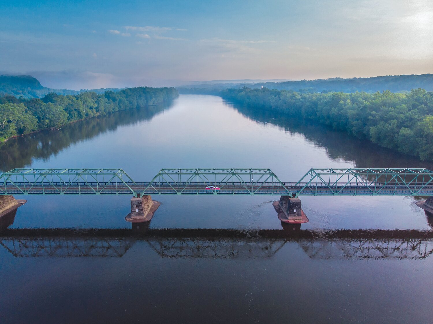 A single car traverses the Uhlerstown-Frenchtown Bridge over the Delaware River on July 20, 2019.