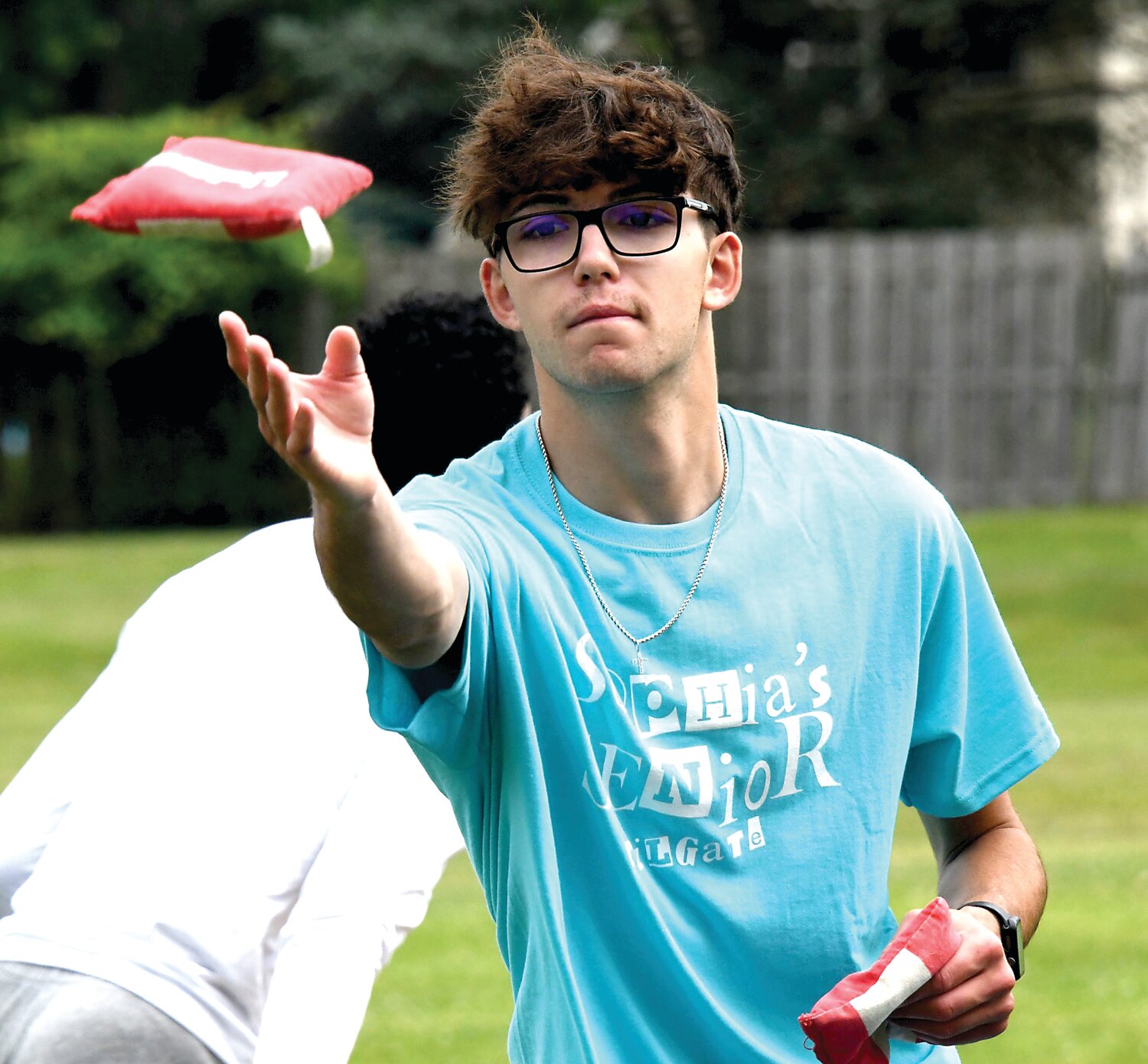 Andrew Leibig, a Bensalem High School senior, plays cornhole with friends during Sophia’s Senior Tailgate.