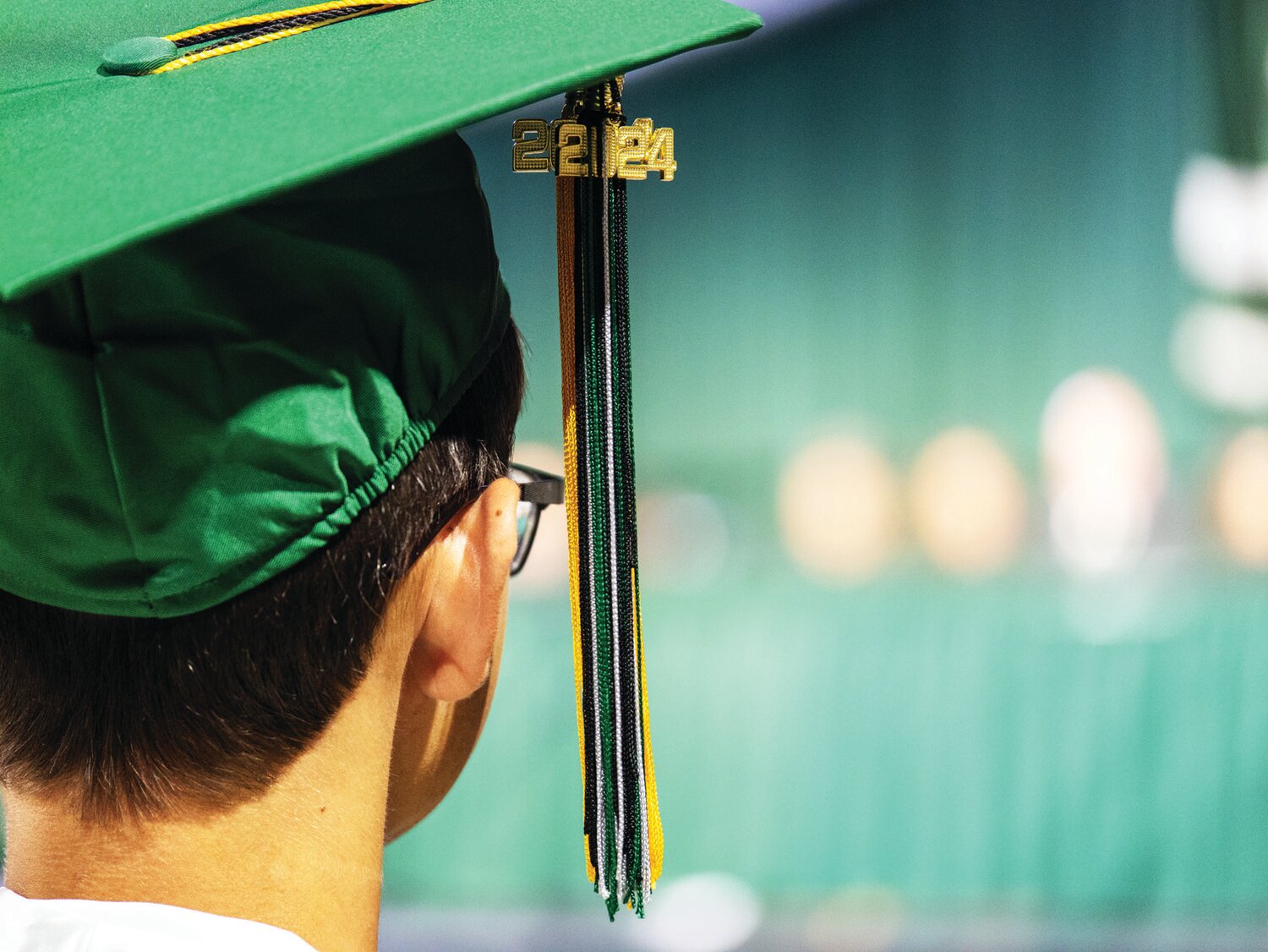 A member of the Class of 2024 watches his June 4 graduation ceremony.