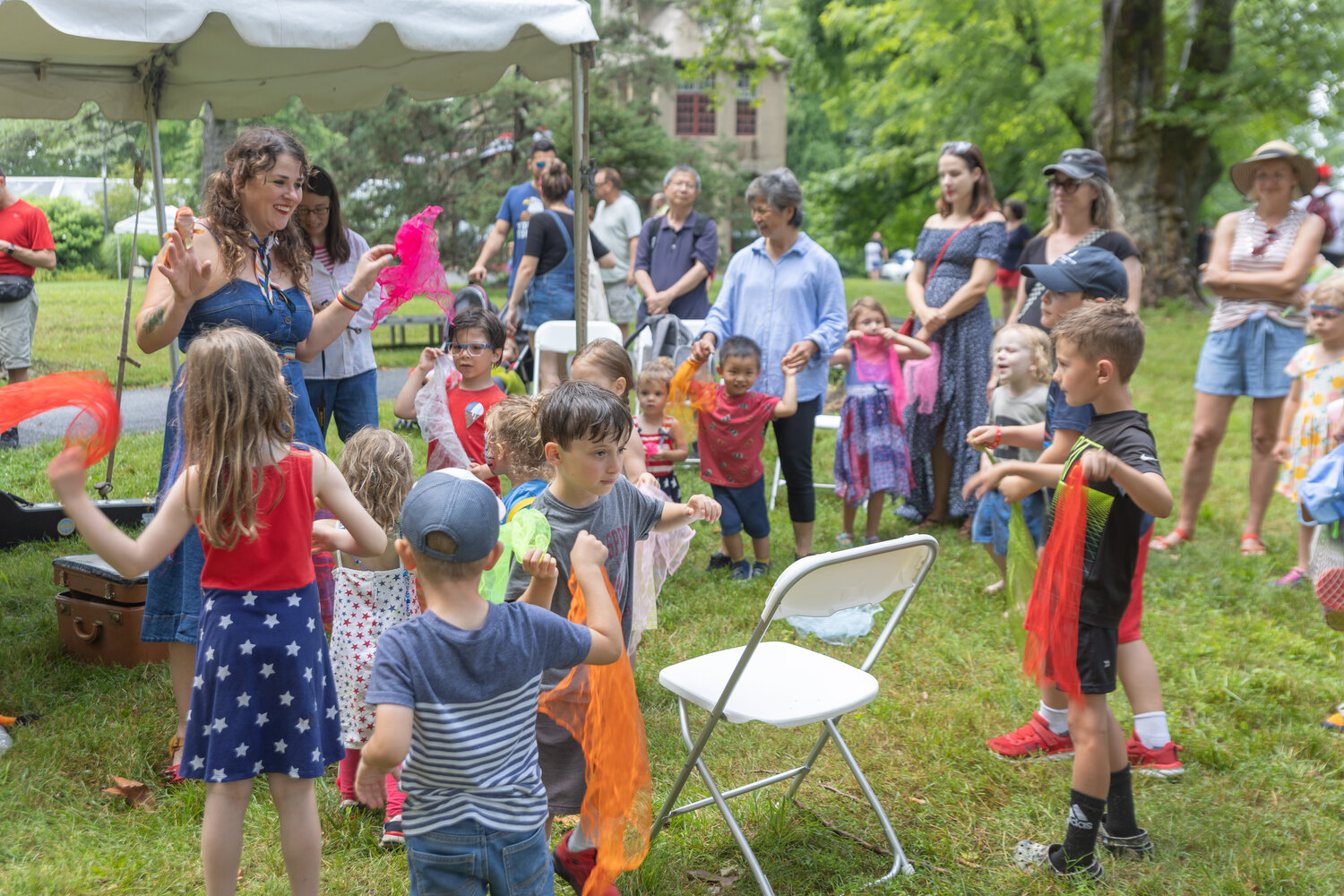 Children enjoy the July 4th entertainment at Fonthill as their parents look on.