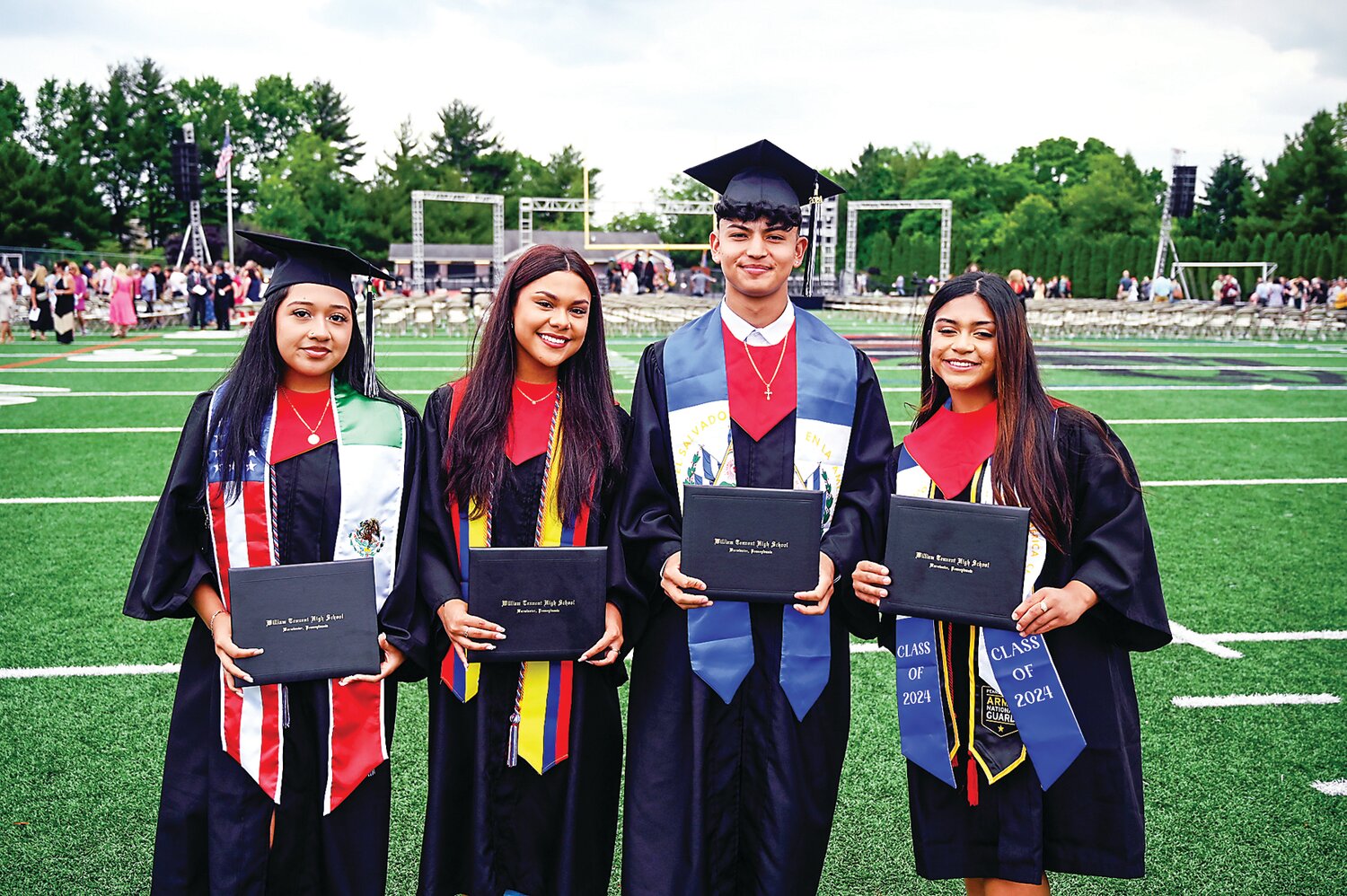 William Tennent graduates hold up their diplomas.