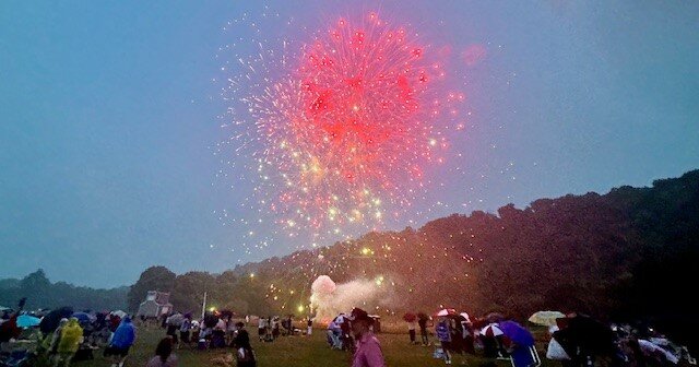 As fireworks explode overhead, some Concert Under the Stars attendees head for the exits, while others stay for the show.