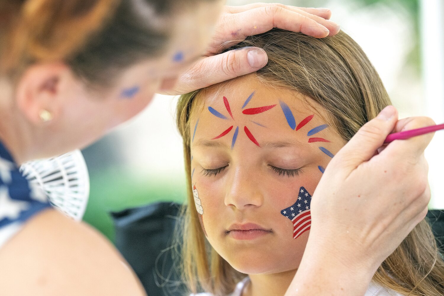 Claire Drellich, 8, gets her face painted during Fonthill Castle’s annual Fourth of July old-fashioned celebration, which took place on the grounds of Henry Mercer’s former home.