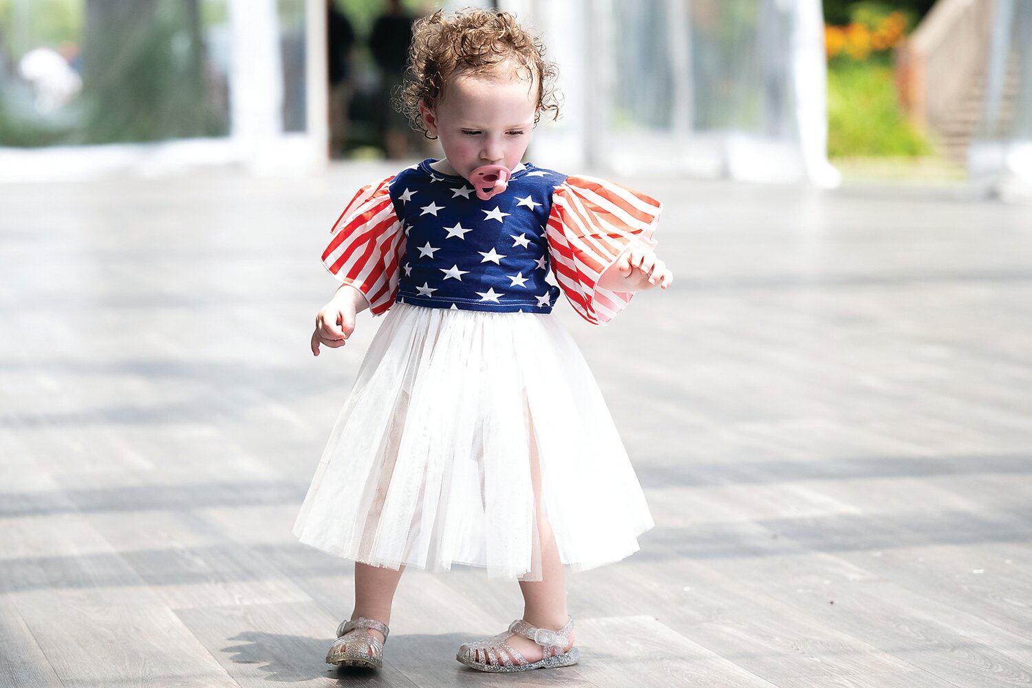 Dressed in her Fourth of July best, 16-month-old Matilda Kirk wanders around the grounds of Henry Mercer’s former home, Fonthill Castle.