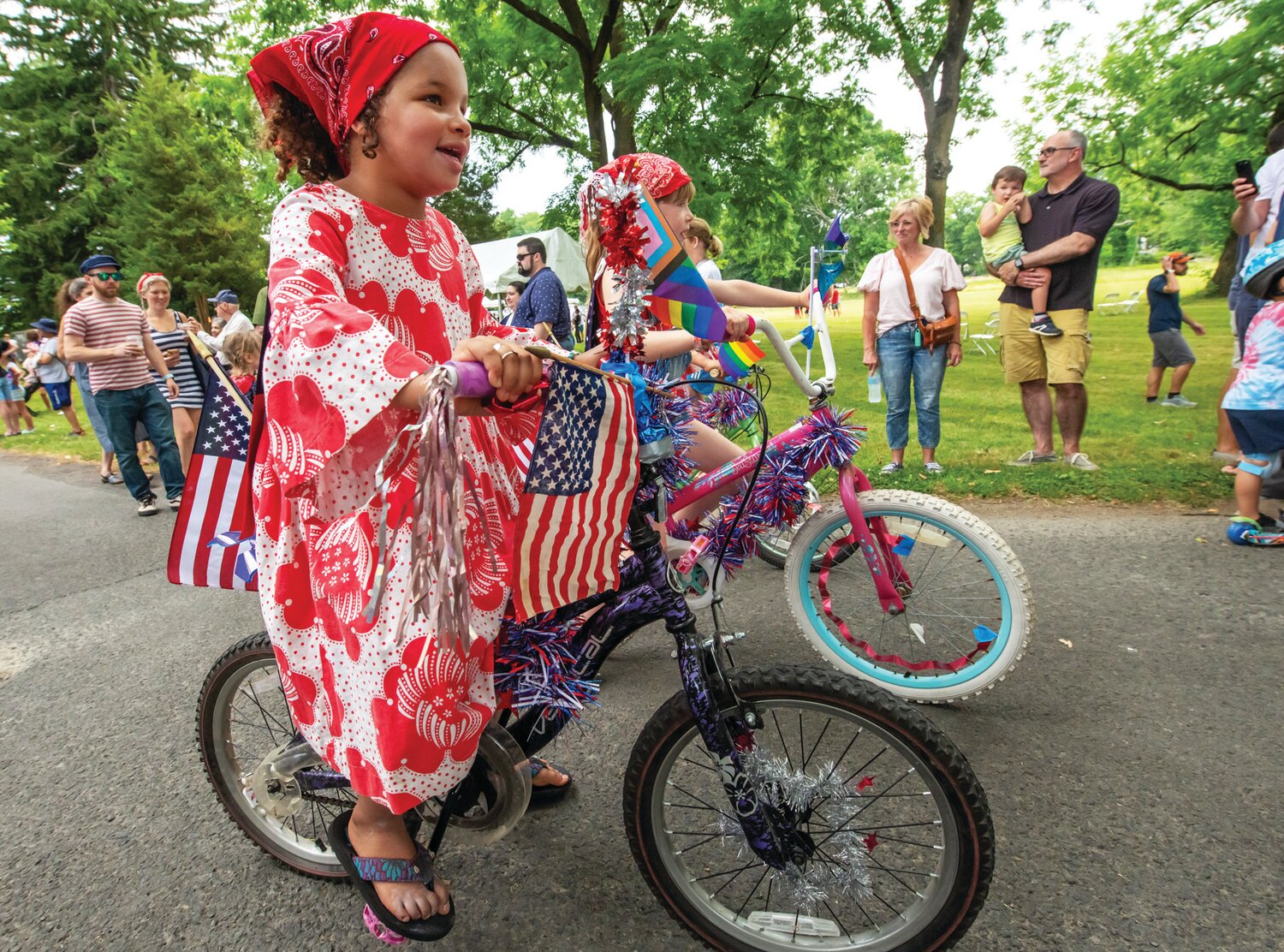 A child rides in the decorated bike parade.