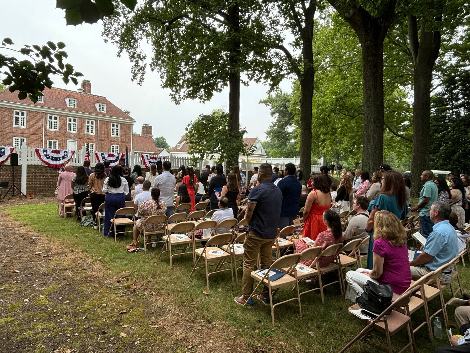 New U.S. citizens stand for the swearing-in.