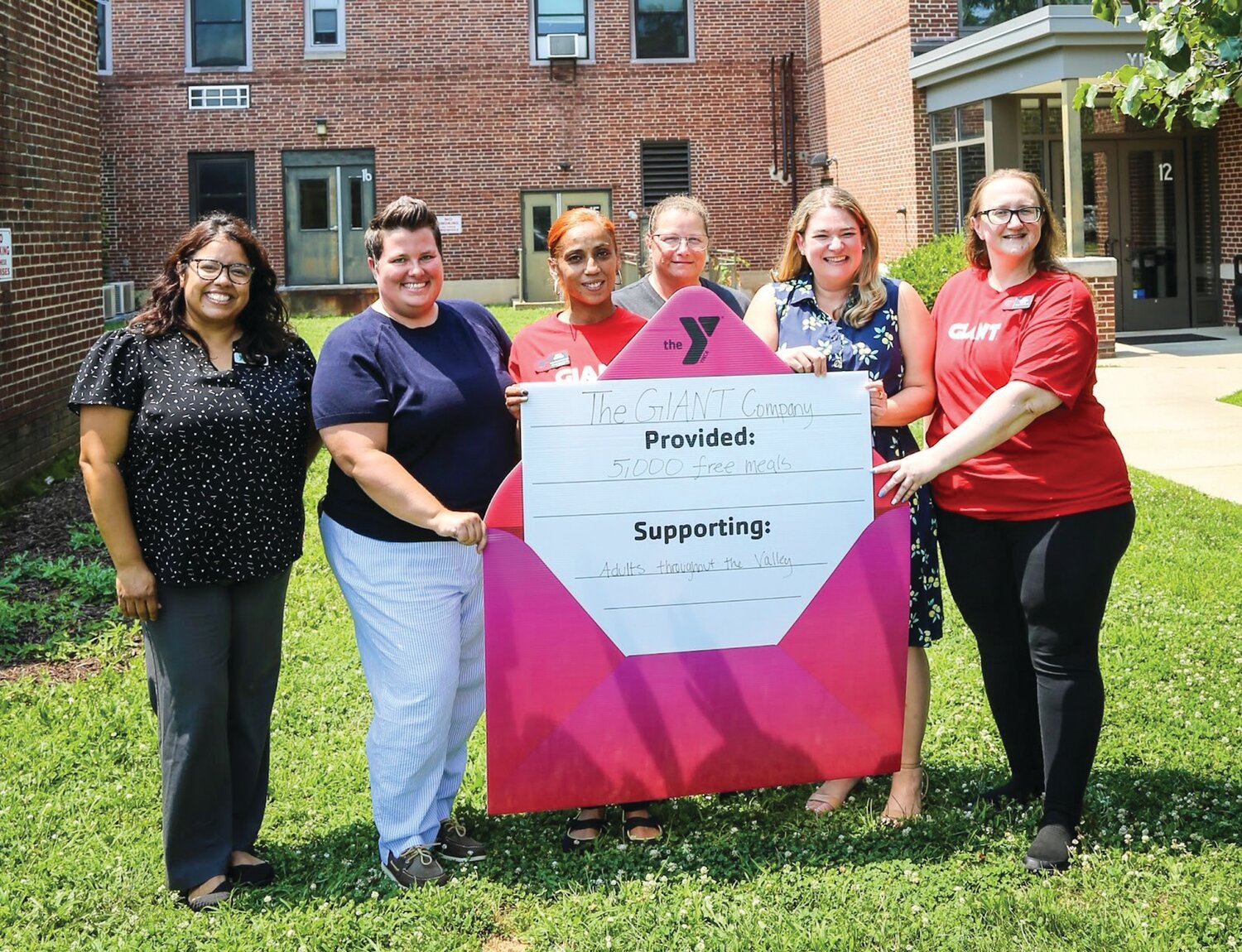 From left: Maribel Tandazo, senior director of community impact for River Crossing YMCA; Maggie Lester, director of corporate fundraising and special events; Aida Matos and Sheri Moyer, volunteers from The GIANT Company; Kate Cohen, vice president of development for the Lehigh Valley region of River Crossing YMCA; and Jen Hinkle, volunteer from The GIANT Company, celebrate the donation of healthy meals to the Y at the Bethlehem branch on July 16.