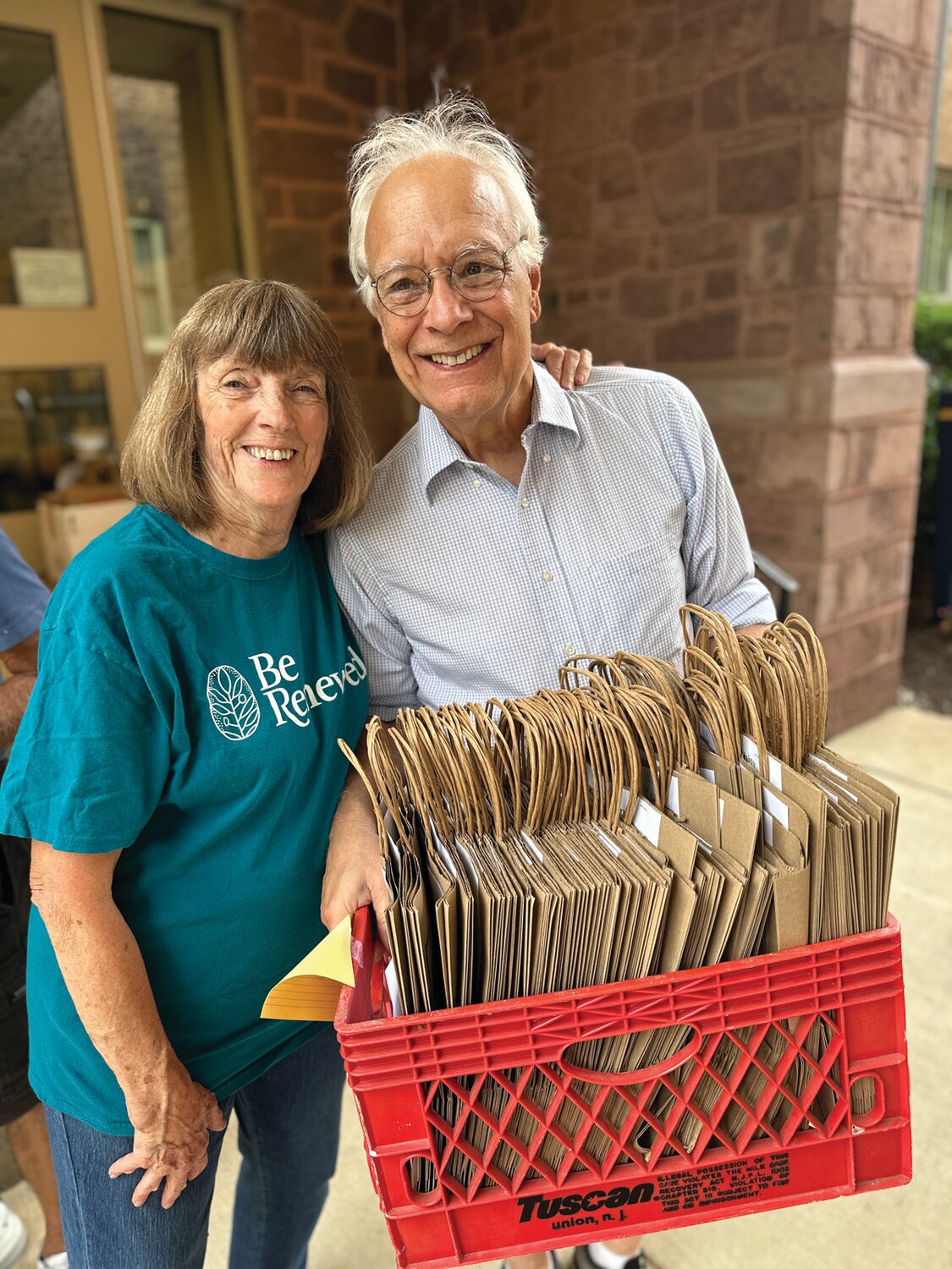 Doylestown Presbyterian Church (DPC) members Diane Alexanderson and Dave Buday prepare to distribute shopping bags to Doylestown residents during DPC’s first Community Food Collection on July 26.