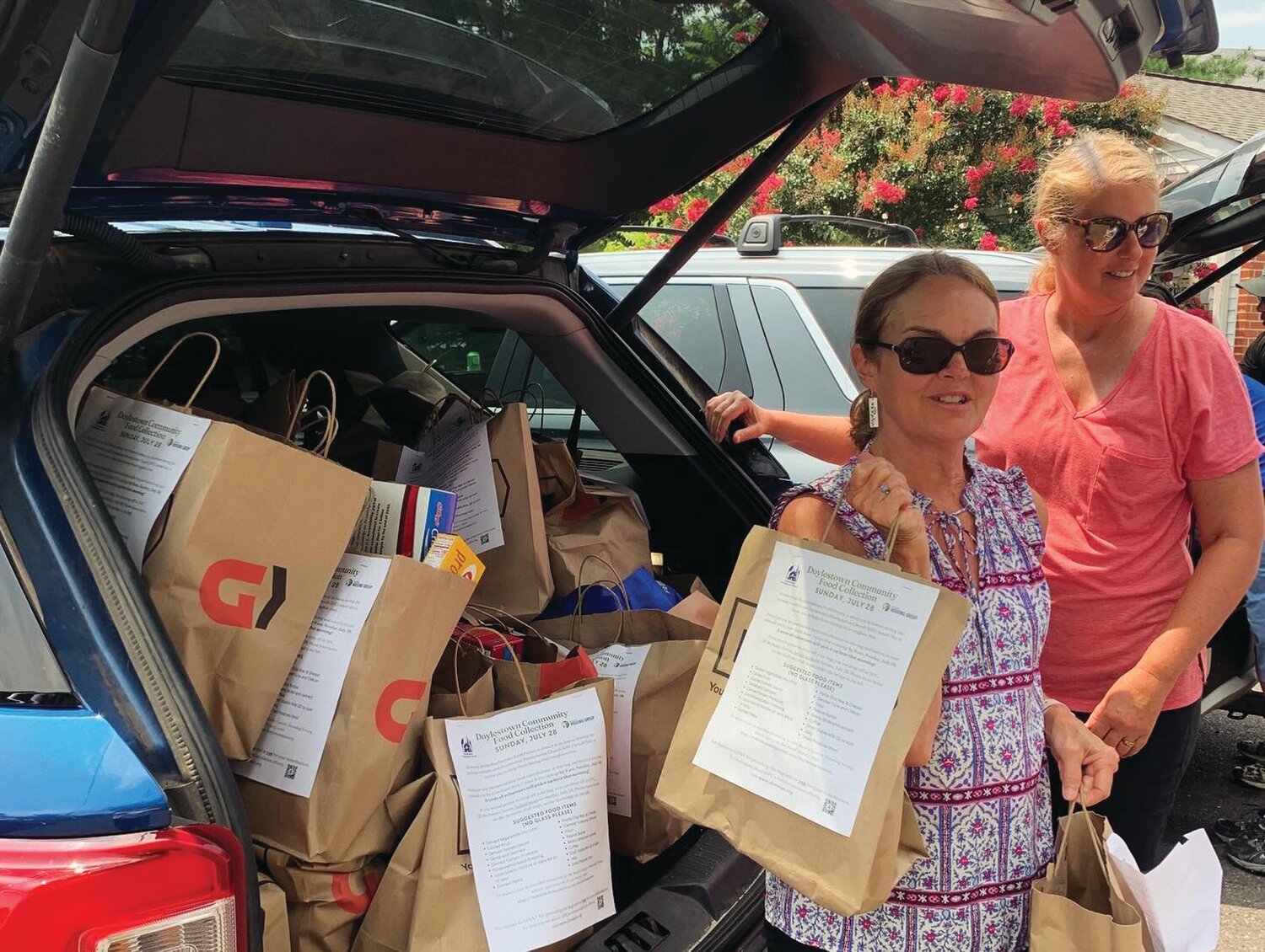 Doylestown Presbyterian Church (DPC) members Mary Shull and Amy Edenson deliver food to the Bucks County Housing Group’s Doylestown Food Pantry on July 28. DPC volunteers picked up nearly 150 shopping bags filled with food by Doylestown residents during DPC’s first Community Food Collection.