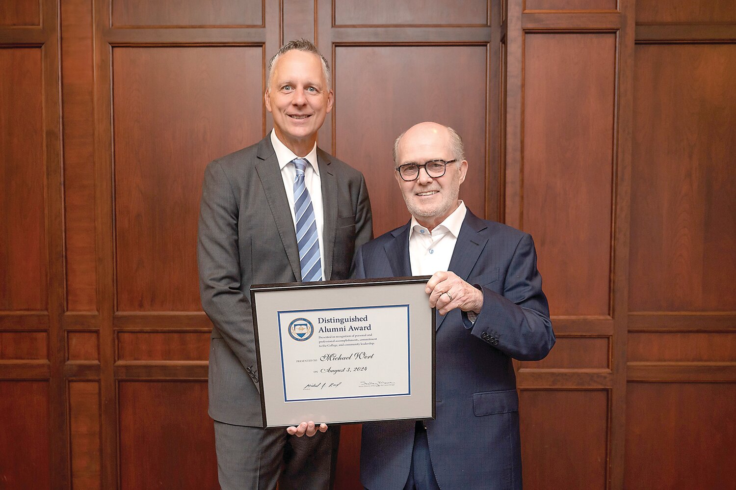 Michael Wert, right, of New Hope, is congratulated by Pennsylvania College of Technology President Michael J. Reed for receiving the Distinguished Alumni Award during the college’s Summer 2024 Commencement ceremonies at the Community Arts Center.