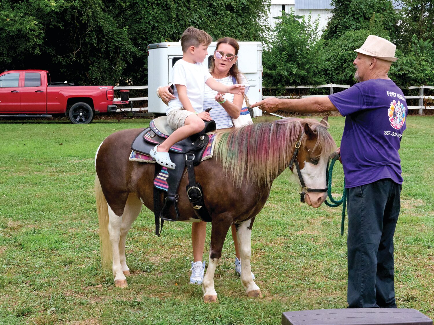 Brenda Pare of Yardley with her son, Cash, as he takes a pony ride during the Sweet Corn Festival Aug. 4 at Charlann Farms  in Lower Makefield.