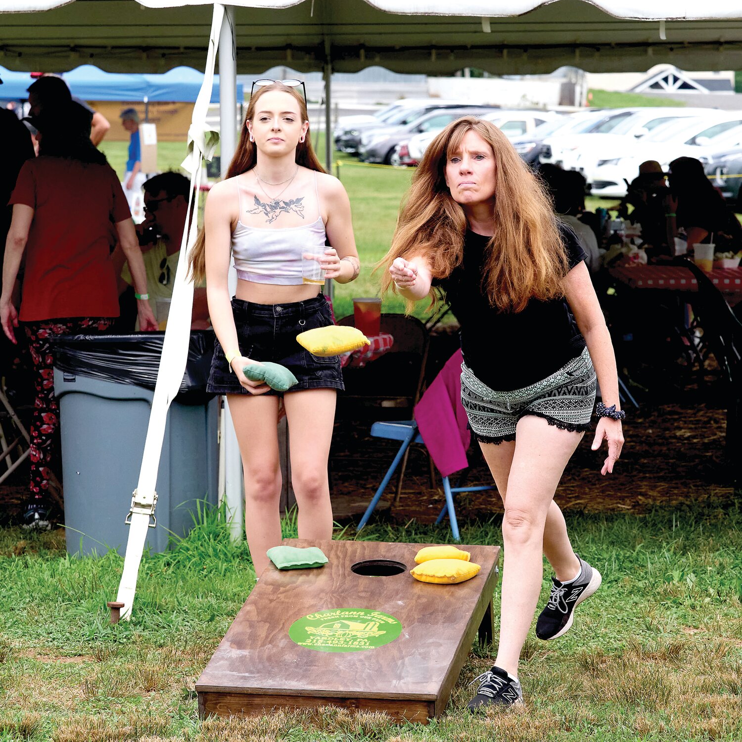 Sierra Mastantoni of Chalfont and Jeannine Eddleman of Southampton play cornhole during the Sweet Corn Festival Aug. 4 at Charlann Farms  in Lower Makefield.