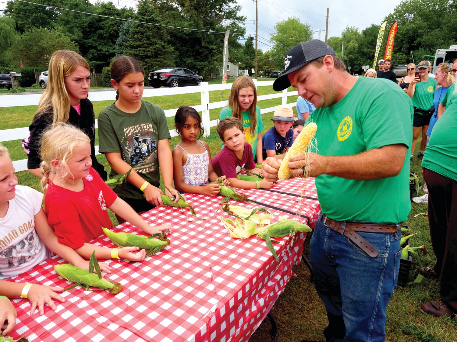 Children get some lessons before the corn husking competition at Charlann Farms’ Sweet Corn Festival.