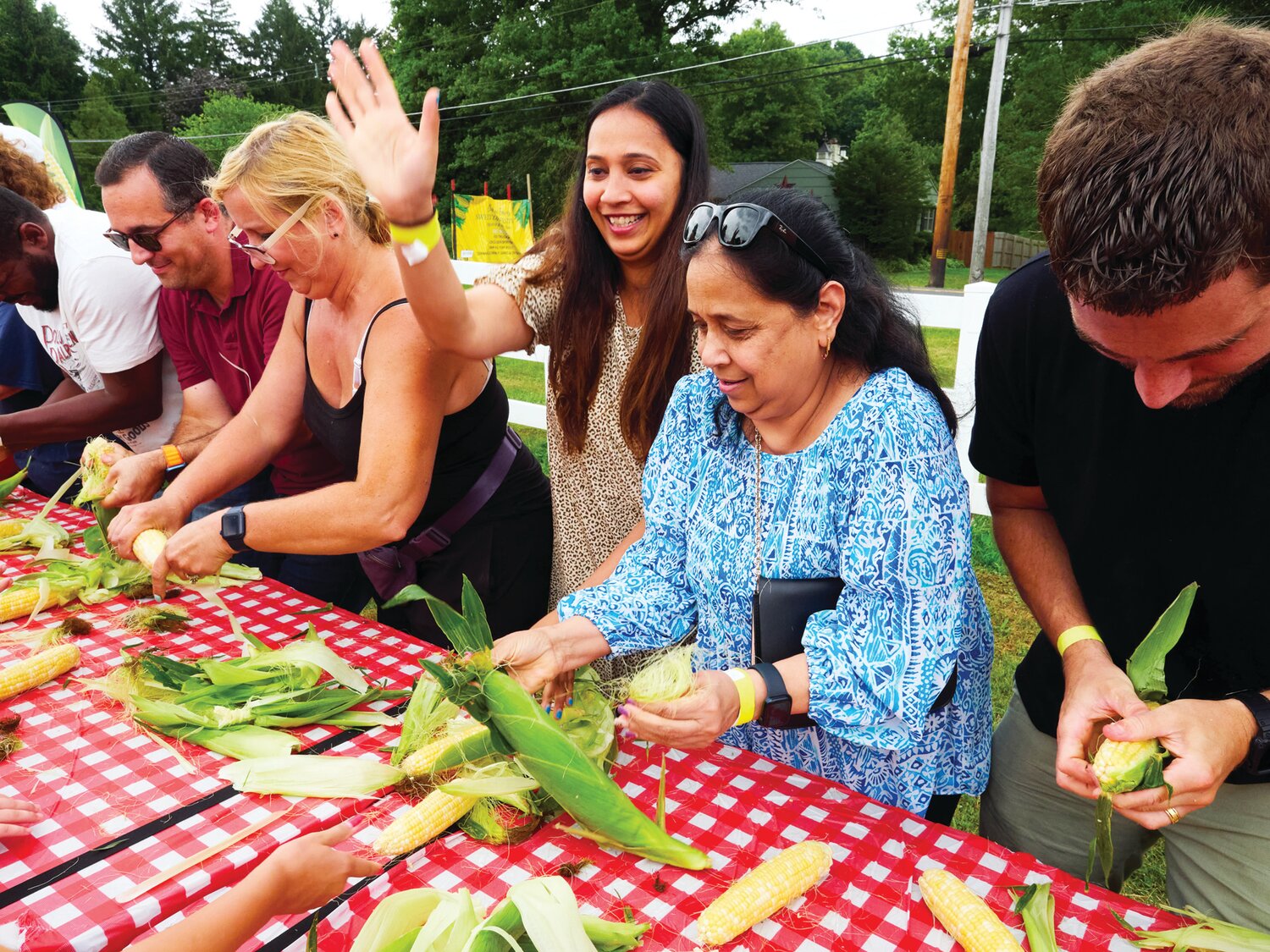 A corn husking competition gets underway during the Sweet Corn Festival Aug. 4 at Charlann Farms  in Yardley.