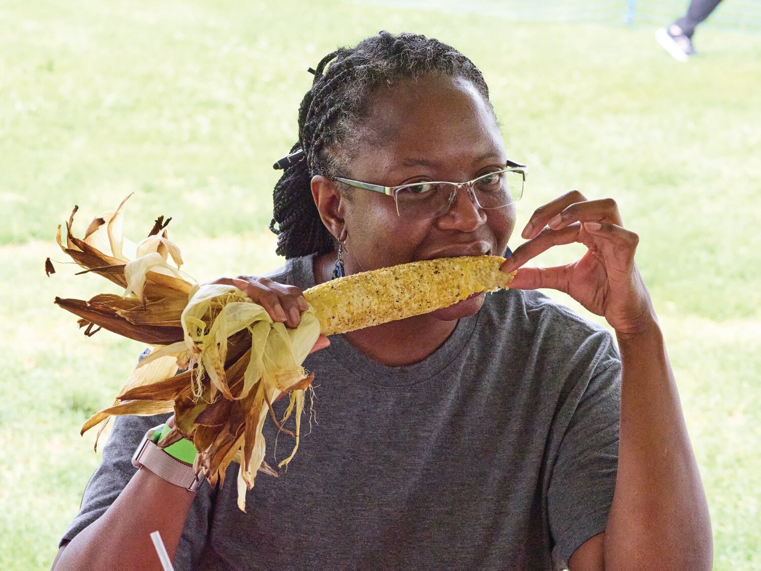 Kim Coleman of Philadelphia enjoys a fresh ear of corn during the Sweet Corn Festival Aug. 4 at Charlann Farms in Yardley.