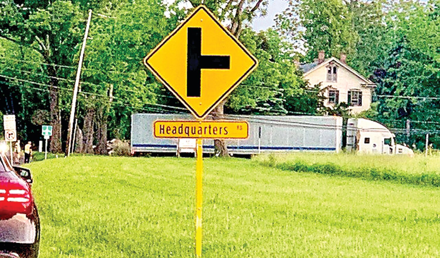 A tractor trailer backs up along Headquarters Road to return to River Road, after its driver realized the truck would not be able to use the covered bridge.