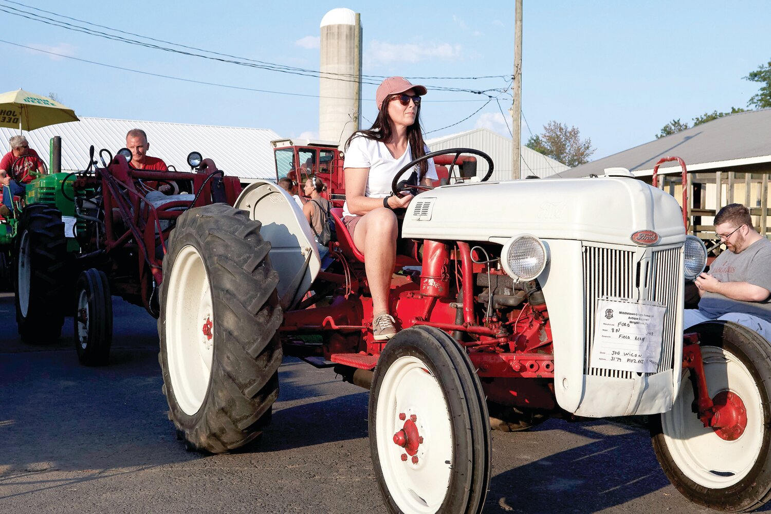 Kathleen Briarly drives Joe Wicen’s tractor in the tractor parade during last year’s Middletown Grange Fair.