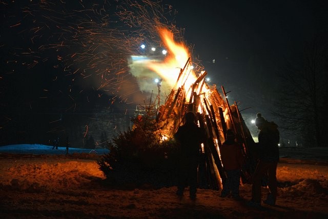 Bonfire sparks snow dark