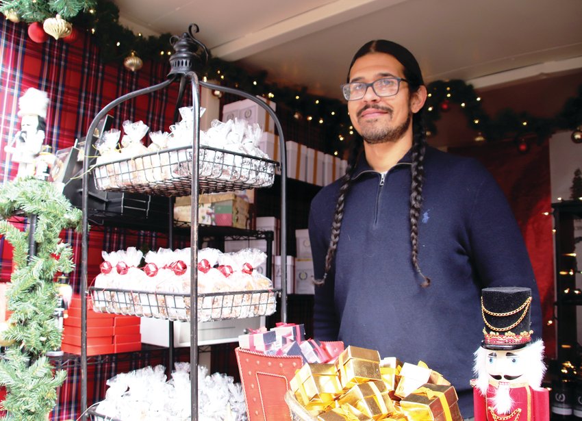 Ryan Anderson of The House of Stewart stands with the small business&rsquo; display of candies and confections at its booth at this year&rsquo;s Cherry Creek Holiday Market. Anderson&rsquo;s favorite is the Baileys Irish Cream because it is the company&rsquo;s seasonal product &mdash; it&rsquo;s only made in the fall.