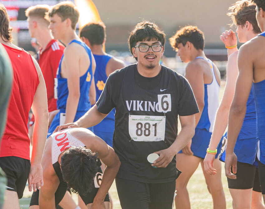 Mossyrock’s Angel Velasco Ortiz rests his hand on the back of teammate Christian Paz-Tapia hug after their 1B boys 4x100 meter relay team (with Matt and Luke Cooper) finishes in fourth place during the State track meet in Yakima on Saturday, May 27.