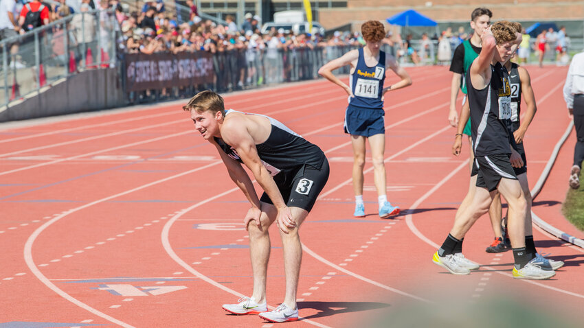 Mossyrock’s Matt Cooper smiles and rests after taking first in the 800 meter run at Zaepfel Stadium in Yakima on Saturday.