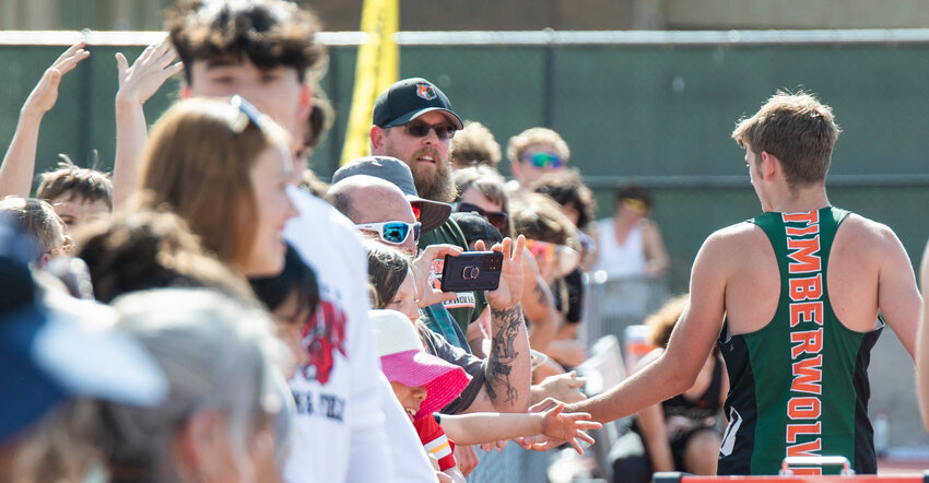 Silver medalist Tony Belgiorno, of Morton-White Pass, gets high-fives from friends and family during the 2B boys State long jump finals in Yakima on Friday, May 26.