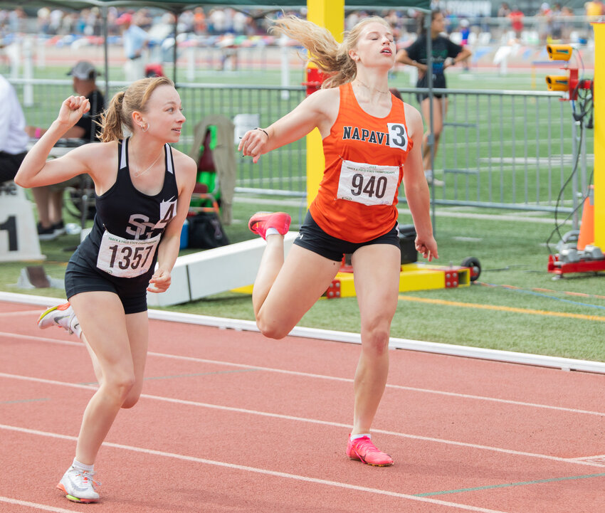 Napavine’s Morgan Hamilton throws herself over the finish line, taking second place by hairs of a second during the 2B girl 200 meter dash State finals in Yakima on Saturday, May 27.