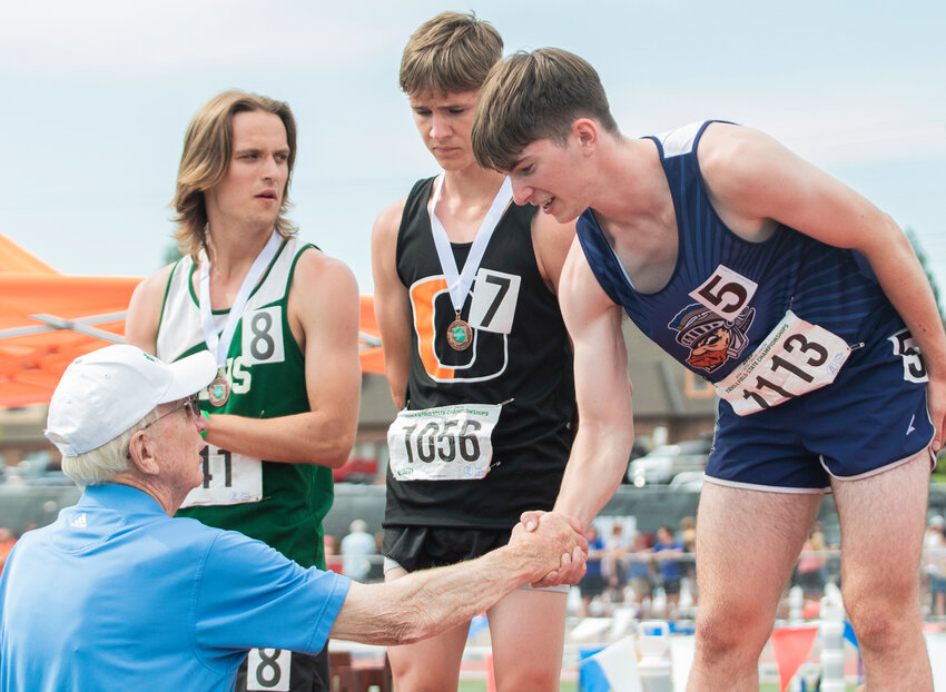 Pe Ell’s second place 100 and 300 meter hurdler Carter Phelps accepts a medal during an award ceremony at the State track and field meet in Yakima on Saturday, May 27.