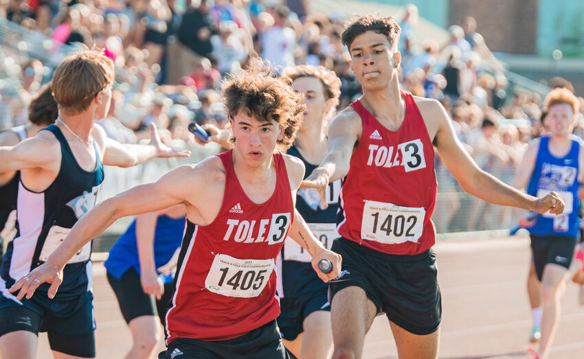 Toledo’s Jordan McKenzie passes the baton to John Rose during the boys 2B 4x400 relay final at State in Yakima on Saturday, May 27.