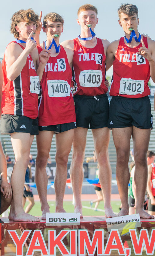 Toledo’s 4x400 relay team of John Rose, Trevin Gale,  Conner Olmstead and Jordan McKenzie smile for a photo during an awards ceremony with their gold medals for the 2B boys 4x400 meter relay State championship during the track and field meet in Yakima on Saturday.