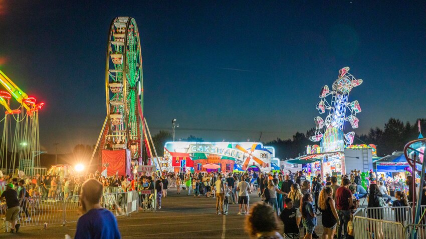 Visitors watch as rides illuminate the Southwest Washington Fairgrounds in 2022.