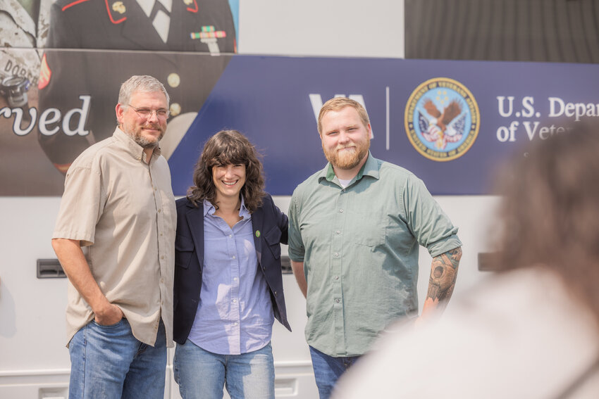 From left, Veterans Memorial Museum Executive Director Chip Duncan, Congresswoman Marie Gluesenkamp Perez and Jesse Lloyd, director of Veterans Journey Forward, smile for a photo outside of the Veterans Affairs Puget Sound Health Care System American Lake Mobile Medical Unit in Chehalis on Wednesday, Aug. 23, 2023.