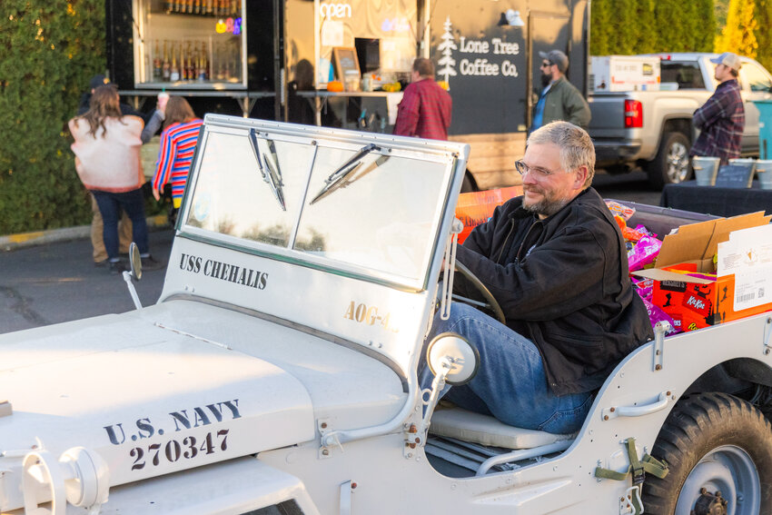 Executive Director Chip Duncan pilots a U.S. Navy Jeep full of candy during a Trunks with Treats event at the Veterans Memorial Museum on Sunday, Oct. 29, 2023.