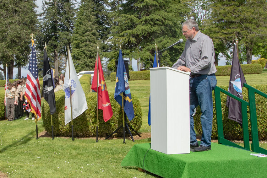 Veterans Memorial Museum Executive Director Chip Duncan shares stories of fallen veterans during a Memorial Day ceremony at Claquato Cemetery in Chehalis on Monday, May 27, 2024.