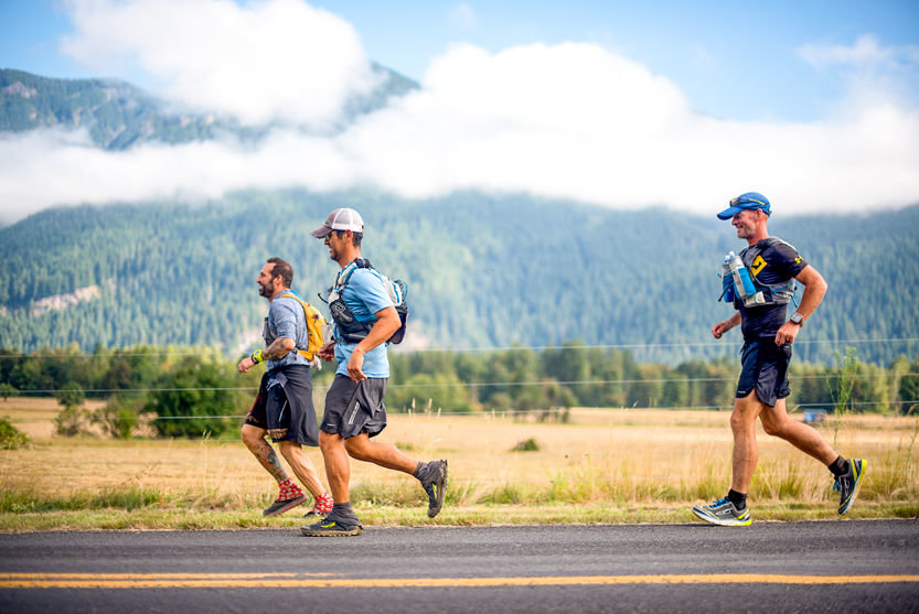 From left: pacer Vito Labello, of San Diego, Calif., George Blancas, 40, of San Diego, Calif., and Bill Thompson, 50, of Pittsburgh, jog along Cline Road in the final stretch of the Bigfoot 200 on Tuesday, Aug. 16, in Randle.