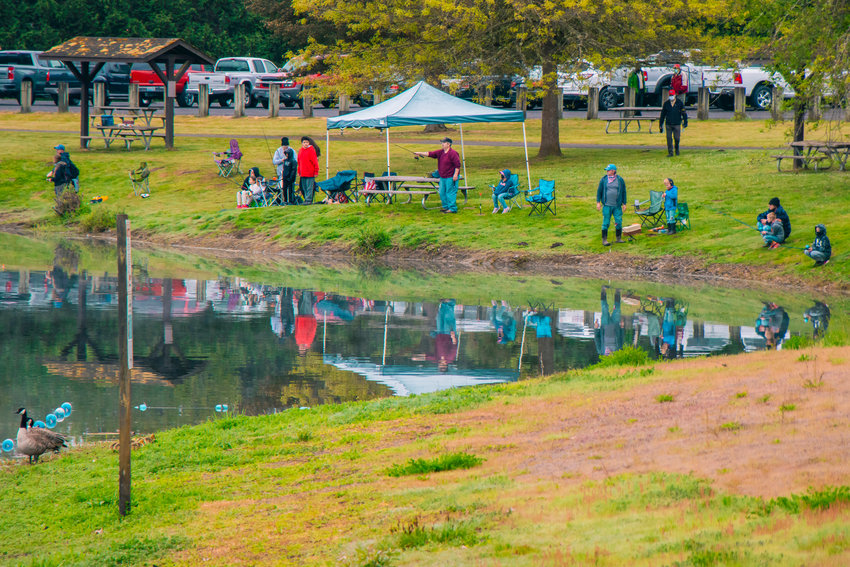 Families gather to fish around South County Pond during the Jim and Penny Lancaster Annual Kids Fishing Derby in Toledo in May 2021.