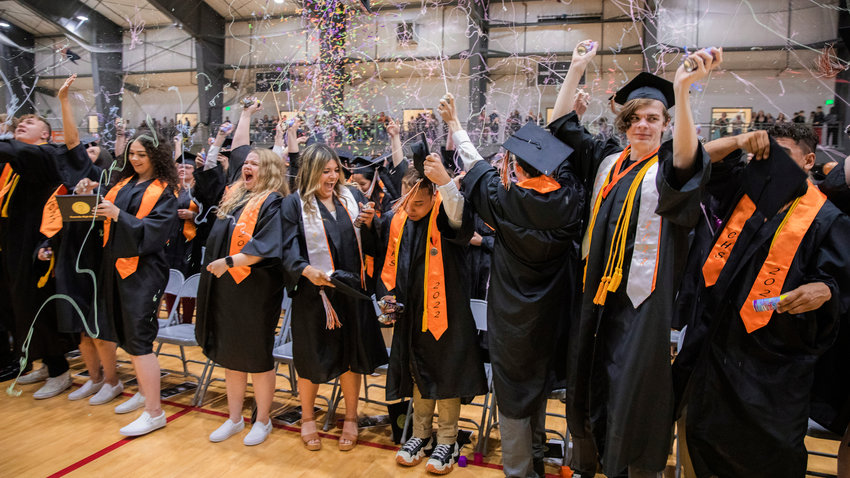 FILE PHOTO &mdash; Confetti and silly string flies through the air over graduates as they turn their tassels in Centralia in June 2022.