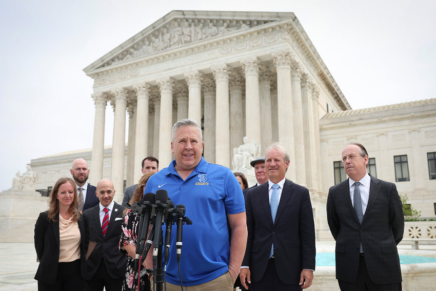 Former Bremerton High School assistant football coach Joe Kennedy answers questions after his legal case, Kennedy vs. Bremerton School District, was argued before the Supreme Court on April 25, 2022, in Washington, DC. Kennedy was terminated from his job by Bremerton public school officials in 2015 after refusing to stop his on-field prayers after football games. (Win McNamee/Getty Images/TNS)