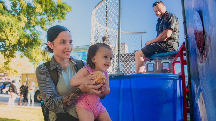 FILE PHOTO &mdash; Genesis Gonzalez prepares to soak Centralia Police Chief Stacy Denham in a dunk tank at George Washington Park during a National Night Out event in August 2022.