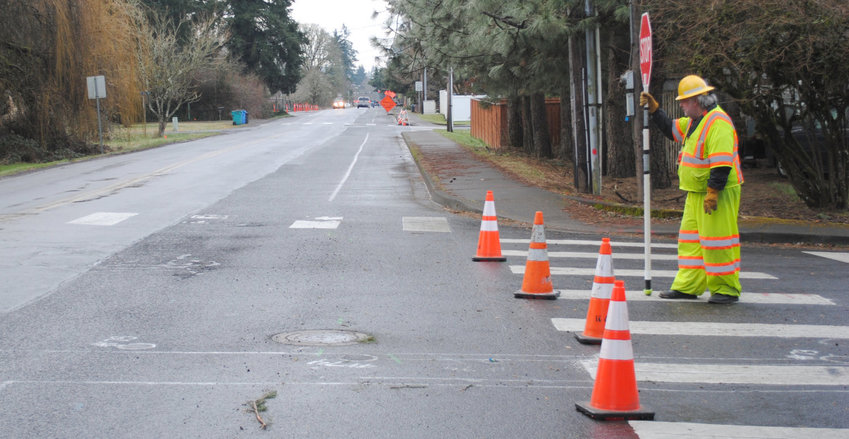 A flagger stands on South Parkway Avenue during construction in 2017 in this file photo. During a meeting with the Washington State Transportation Commission, state officials said construction jobs make up the largest percentage of industry types in Battle Ground and La Center.