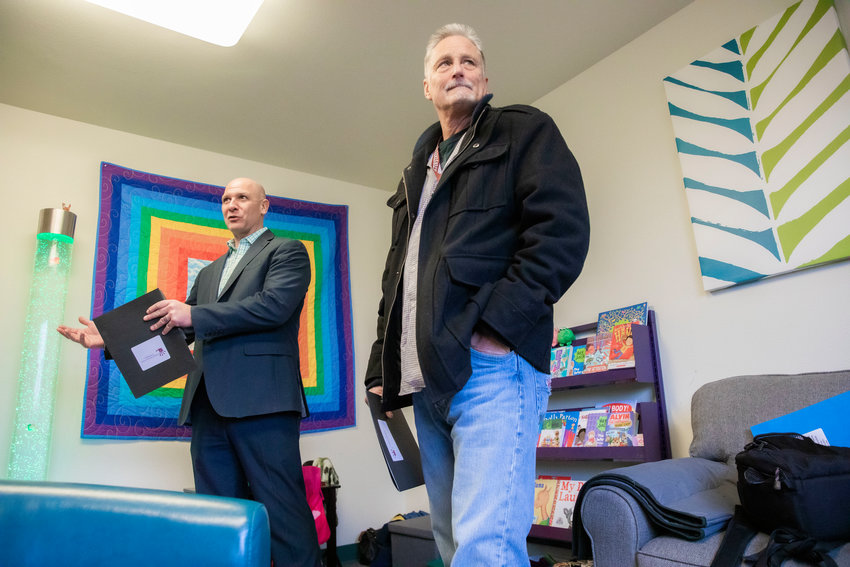 State Sen. Jeff Wilson, right, asks questions about funding and upcoming bills that would help the Youth Advocacy Center of Lewis County and the children they serve during a tour in December 2022.