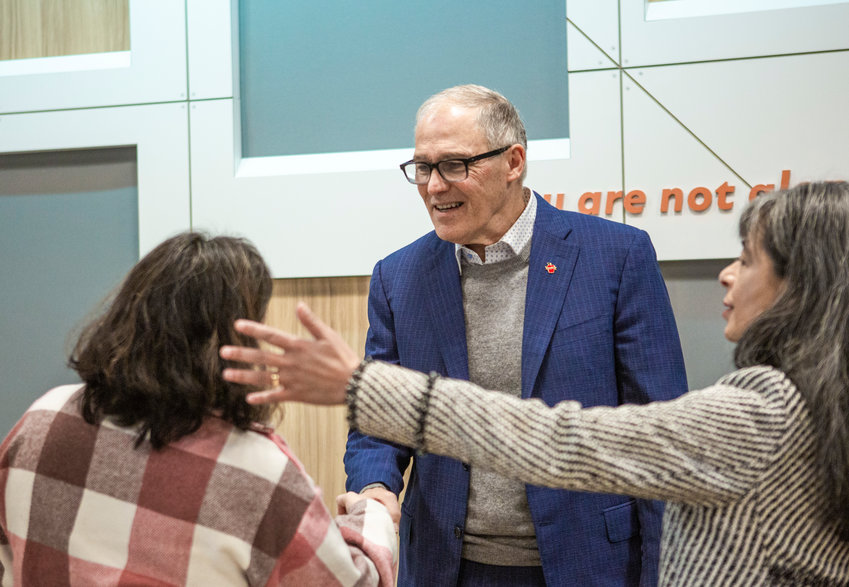 Gov. Jay Inslee introduces himself to Chehalis Tribal Fifth Council Rachelle Ferguson at Maple Lane&rsquo;s new behavioral health facility on Friday, Jan. 27.