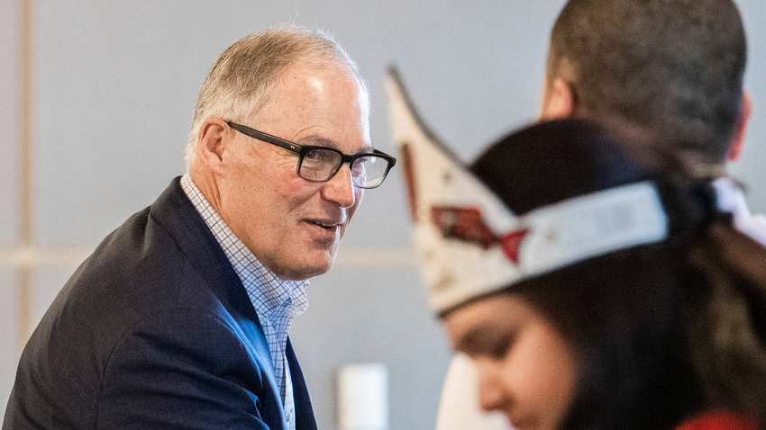 Governor Jay Inslee smiles and shakes hands during a meeting at the Chehalis Tribe Community Center last March in Oakville.
