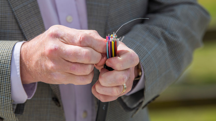 Frank Corbin holds up a fiber optic cable outside Ramblin&rsquo; Jack&rsquo;s Ribeye in Napavine last April.