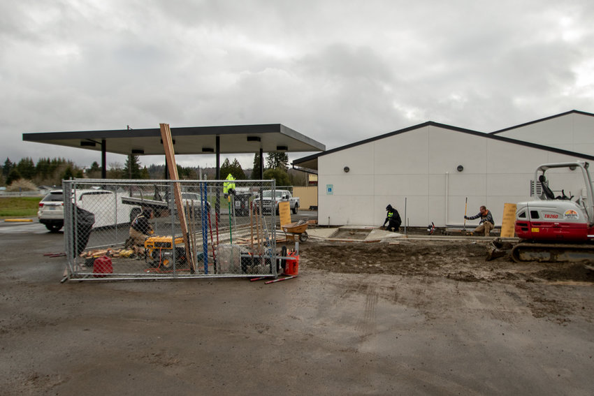 A crew with Resound Energy works to install new electric vehicle charging stations at the Salkum Timberland Library on Tuesday, April 4.