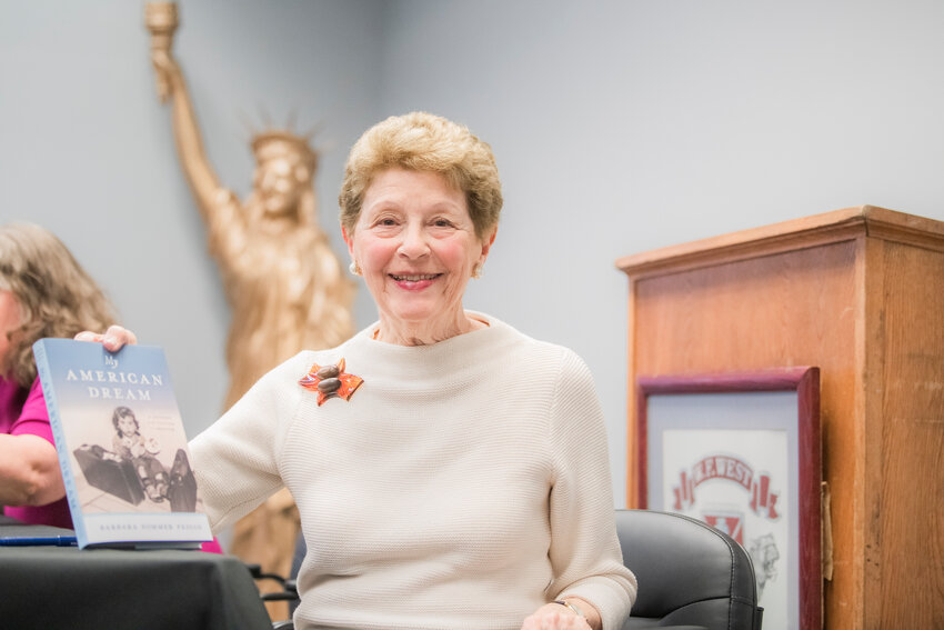 Barbara Feigin smiles for a photo with her book &ldquo;My American Dream,&rdquo; during a presentation at W.F. West High School in Chehalis on Monday, April 24, 2023.