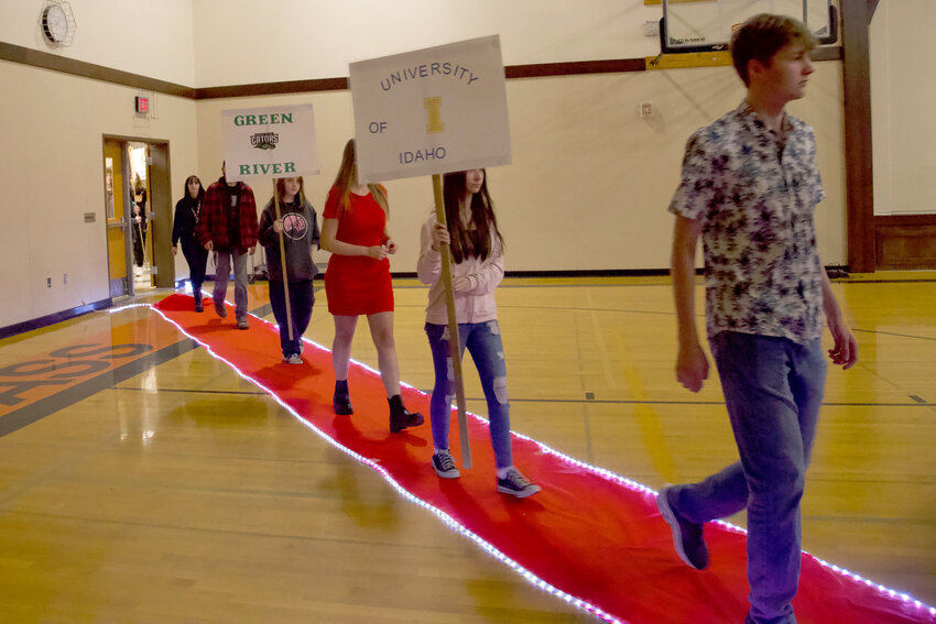 White Pass middle schoolers and graduating seniors parade into the White Pass Junior/Senior High School gym on Monday, May 1, while denoting the different schools and other destinations they have decided on as their next step.