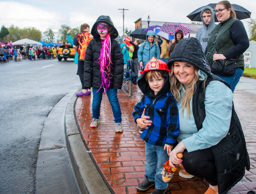 Visitors gather under hoods and umbrellas for the Vader May Day parade Saturday, May 6.