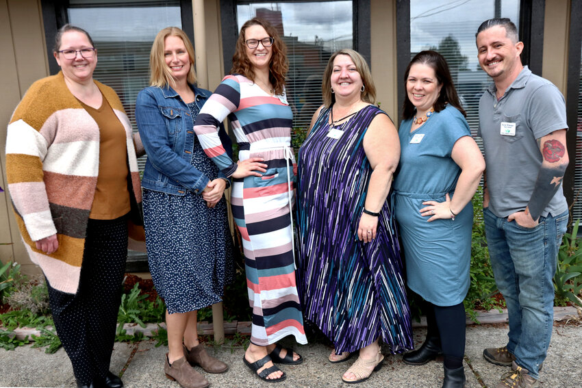 Six of the seven members of the Toledo Neighbors Program board, from left, Cherie Devore, Brooke Acosta, Tessa Clark, Amber Buck, Heather Garman and Kyle Wheeler, pose for a photo outside the Toledo Senior Center during an event on Saturday, May 6. Board member Pam Meade is not pictured.